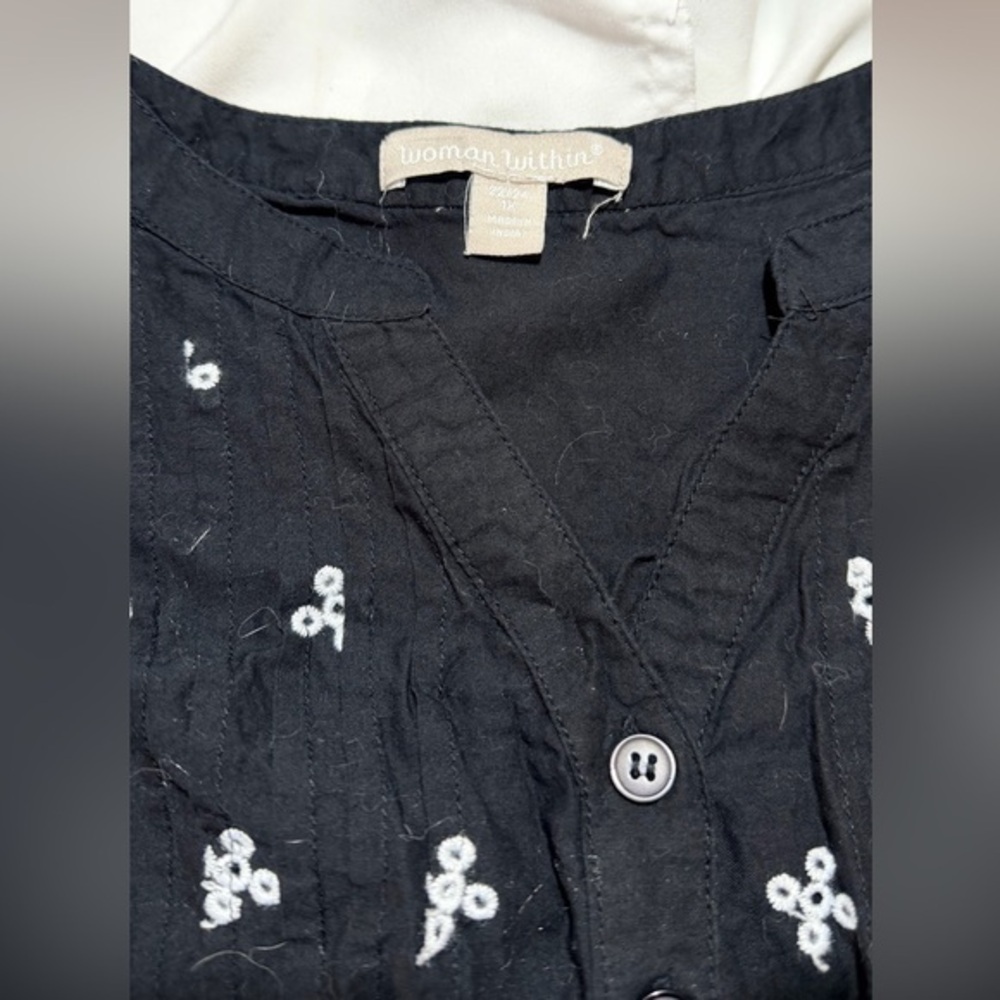 Woman Within Black Top with White Floral Embroidery